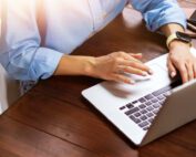 Man working on lead tracking software on laptop