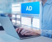 Person on computer with digital graphics popping off screen