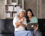 Women on couch looking at laptop together