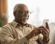 Men using cellphone on couch