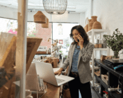 Women revising computer in shop