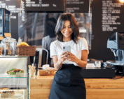 Women smiling using phone in restaurant