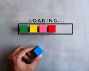 Person adding a block to a line of blocks symbolizing a web page loading