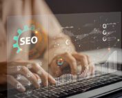 Person working on a computer with a graphic representing SEO overlayed