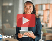 Woman holding tablet while smiling.