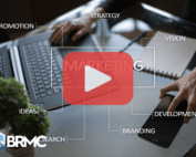 A person works on a laptop with marketing terms like “Promotion,” “Strategy,” and “Branding” overlaid on screen.