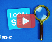 A blue card with the words “LOCAL SEO” next to a magnifying glass, symbolizing search optimization.