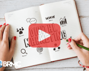 An open notebook with sketches and keywords related to digital marketing, including icons for social media, audience, and analysis.