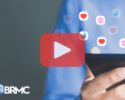 A person holding a smartphone with floating social media icons (likes, hearts, comments) and a large play button overlay, symbolizing video content and online engagement.