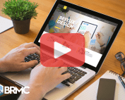 Person using laptop with website on screen and red play buttom overlay.