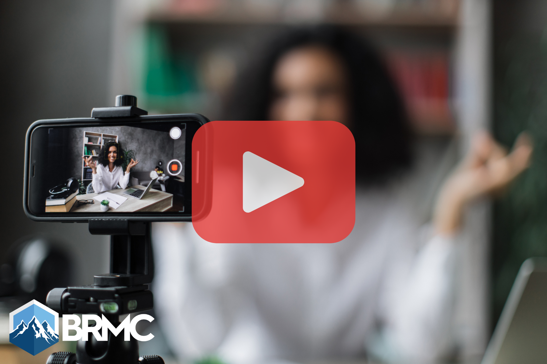 Woman recording video with phone and red play buttom ovverlay.