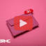 Envelope with pink background. Red play button overlay and BRMC logo.