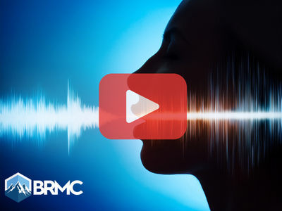 Outline of human face and voice. Red play buttom overlay and BRMC logo
