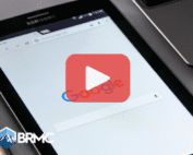 Tablet with google searxh on screen. Red play button overlay and BRMC logo.
