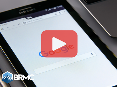 Tablet with google searxh on screen. Red play button overlay and BRMC logo.