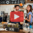 Small business owners in cofee shop. Red play buttom overlay and BRMC logo.