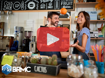 Small business owners in cofee shop. Red play buttom overlay and BRMC logo.