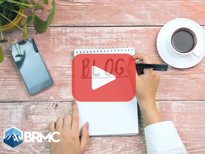 Woman writing on notepad words BLOG. Red play buttom overlay and BRMC logo.