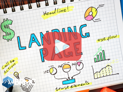 Notebook page with words: Landing Page and images. Red play buttom overlay and BRMC.