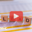 Wooden blocks with words lead, red play buttom overlay and BRMC logo.