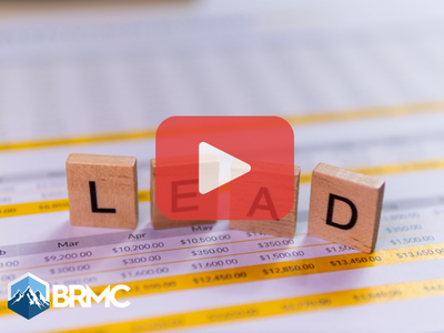 Wooden blocks with words lead, red play buttom overlay and BRMC logo.